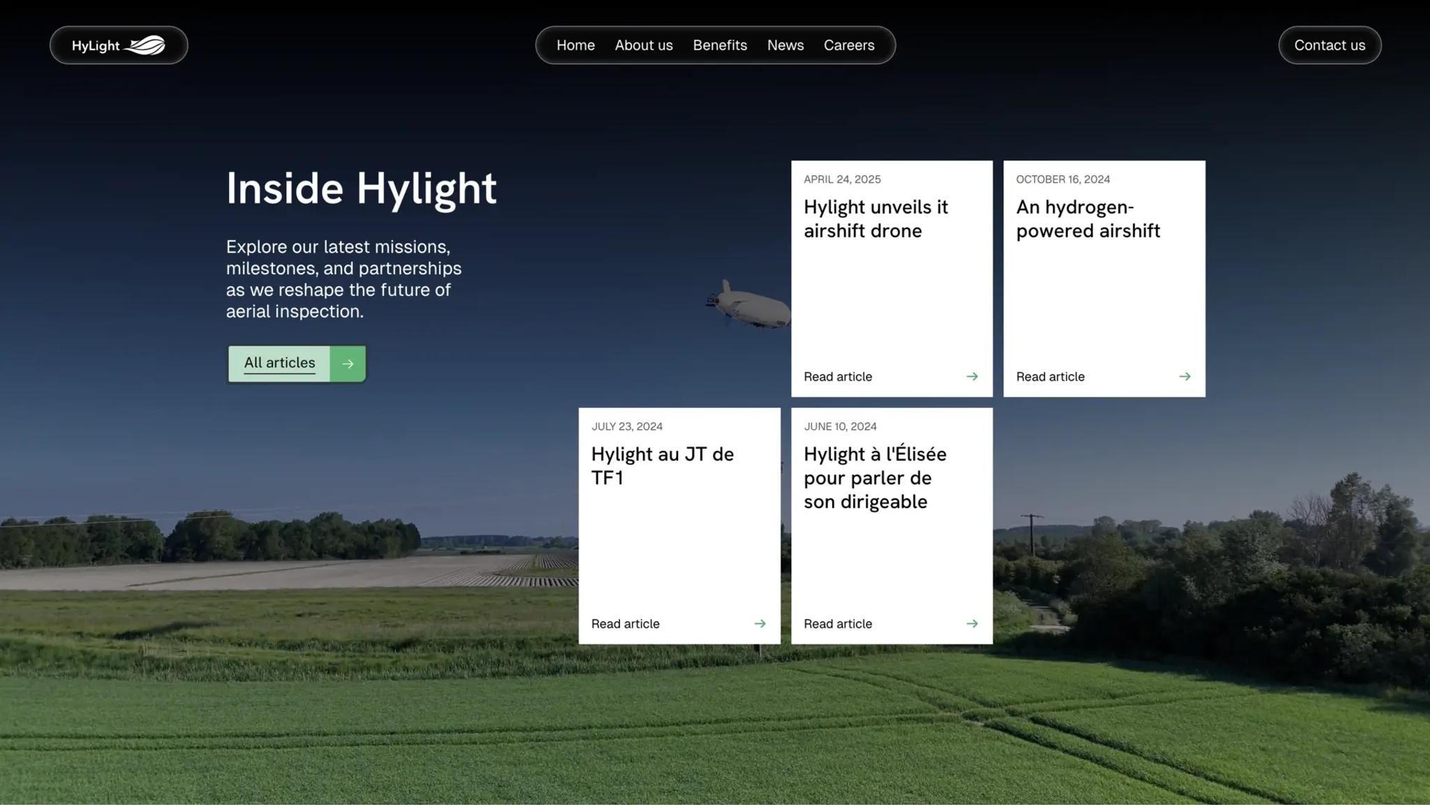 Hylight news page “Inside Hylight”: article cards over green farmland, an airship in the sky