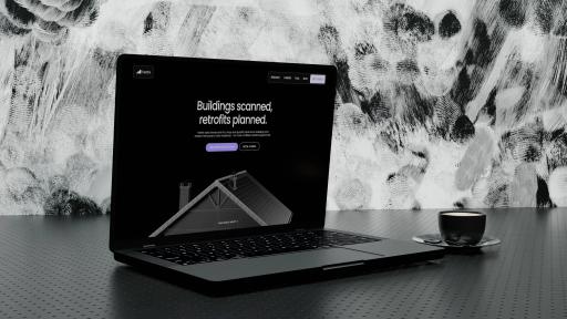 The Kestrix website open on a laptop: “Buildings scanned, retrofits planned.” above a 3D cutaway of a house roof