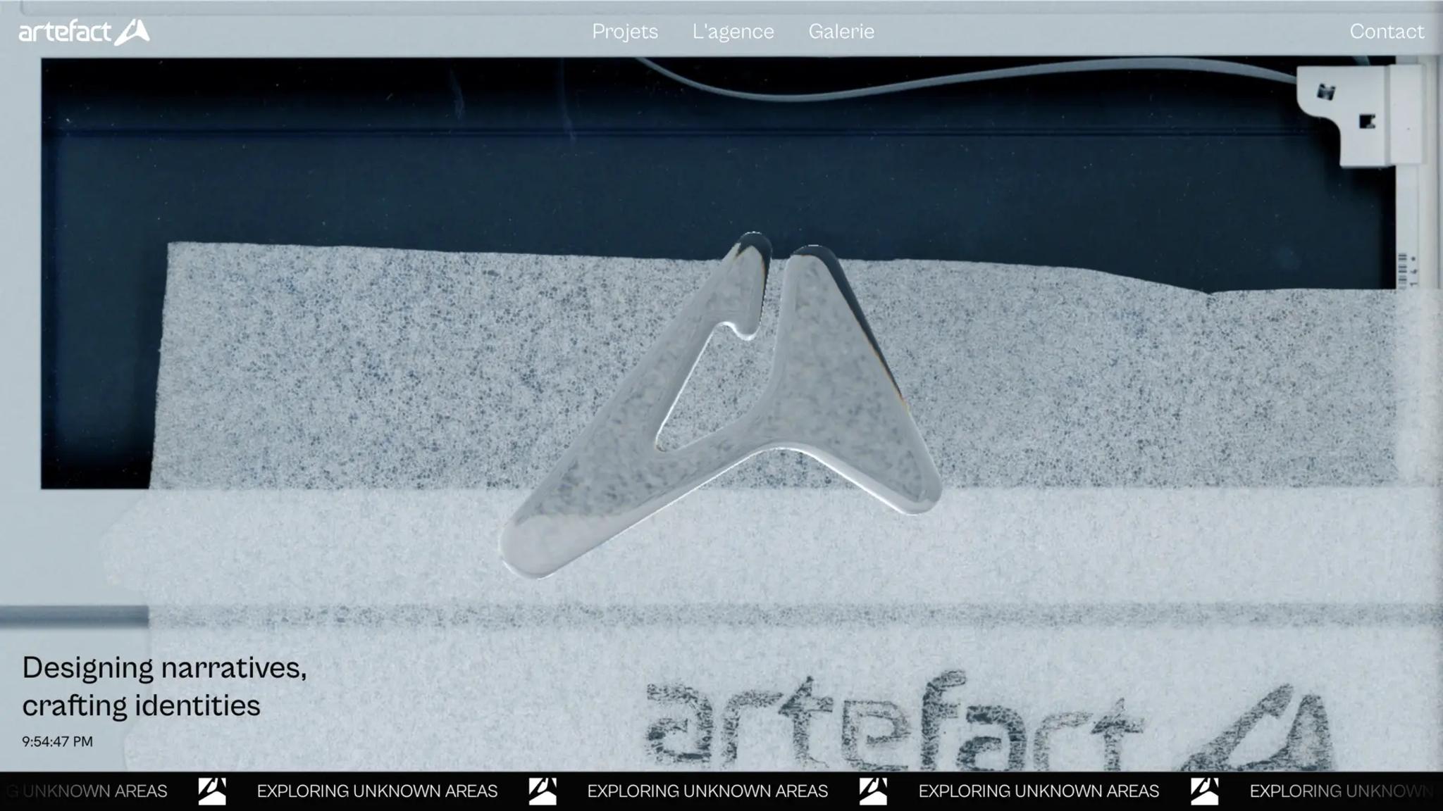 Artefact page: a glass version of the Artefact logo resting on granite, with “Designing narratives, crafting identities”