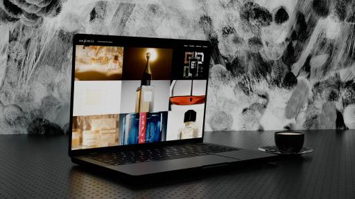 The Une Autre Île Productions website open on a laptop: a grid of perfume and luxury advertising stills