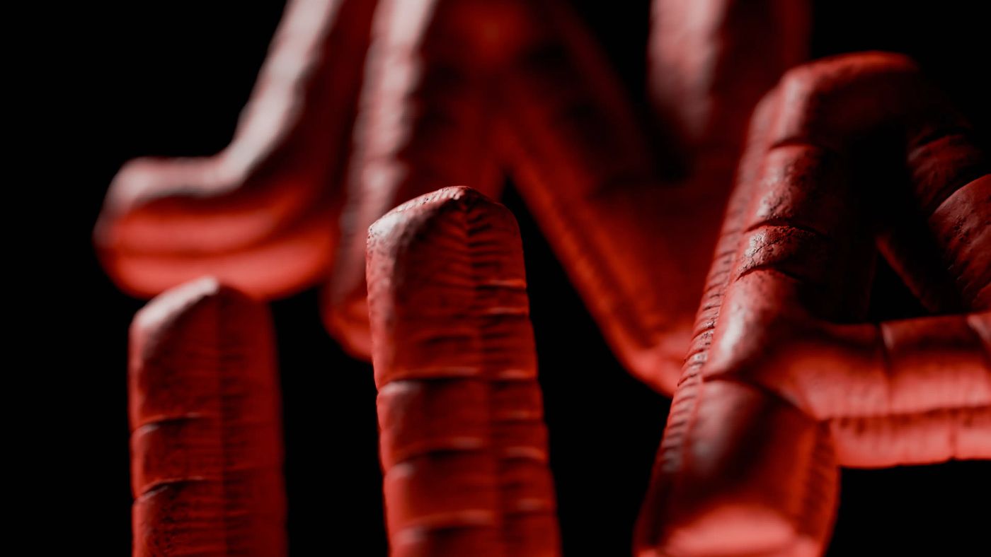 Close-up of the red, ribbed 3D letters of the Junca logo on black