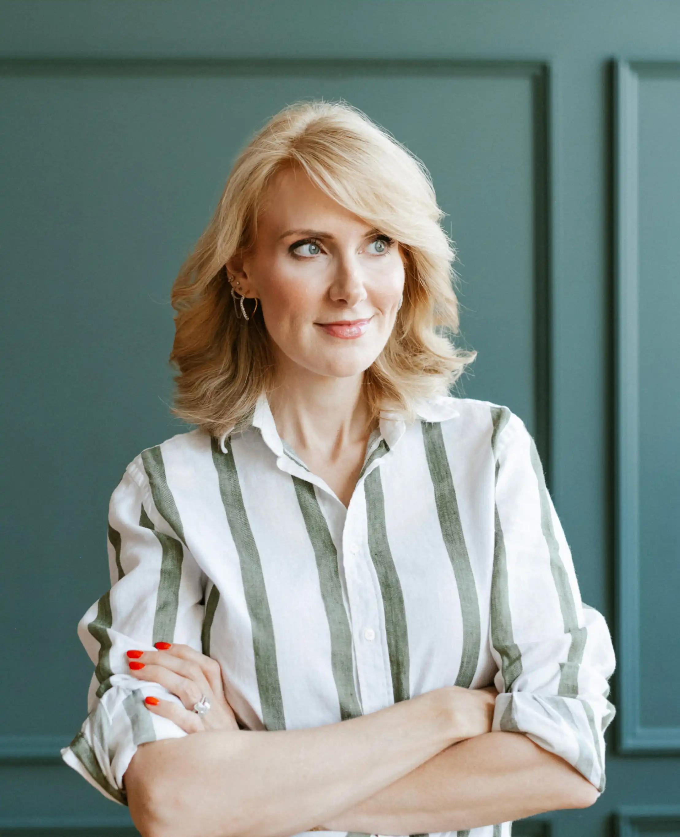 Sharon McMahon on a couch, smiling