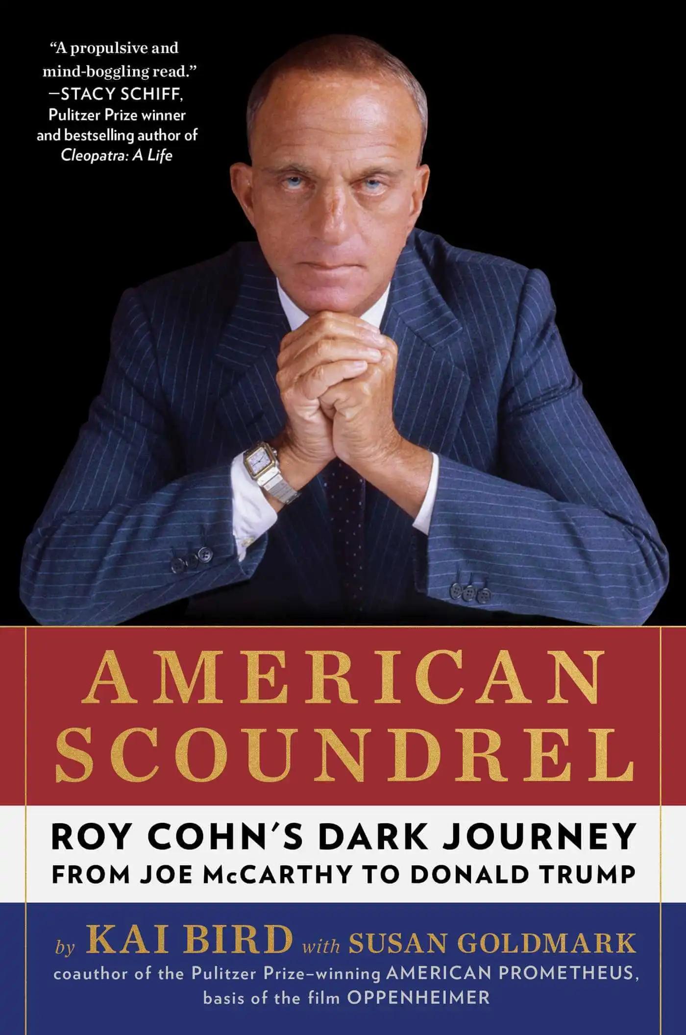 Cover image for American Scoundrel picturing Roy Cohn leaning forward towards the camera with folded hands.