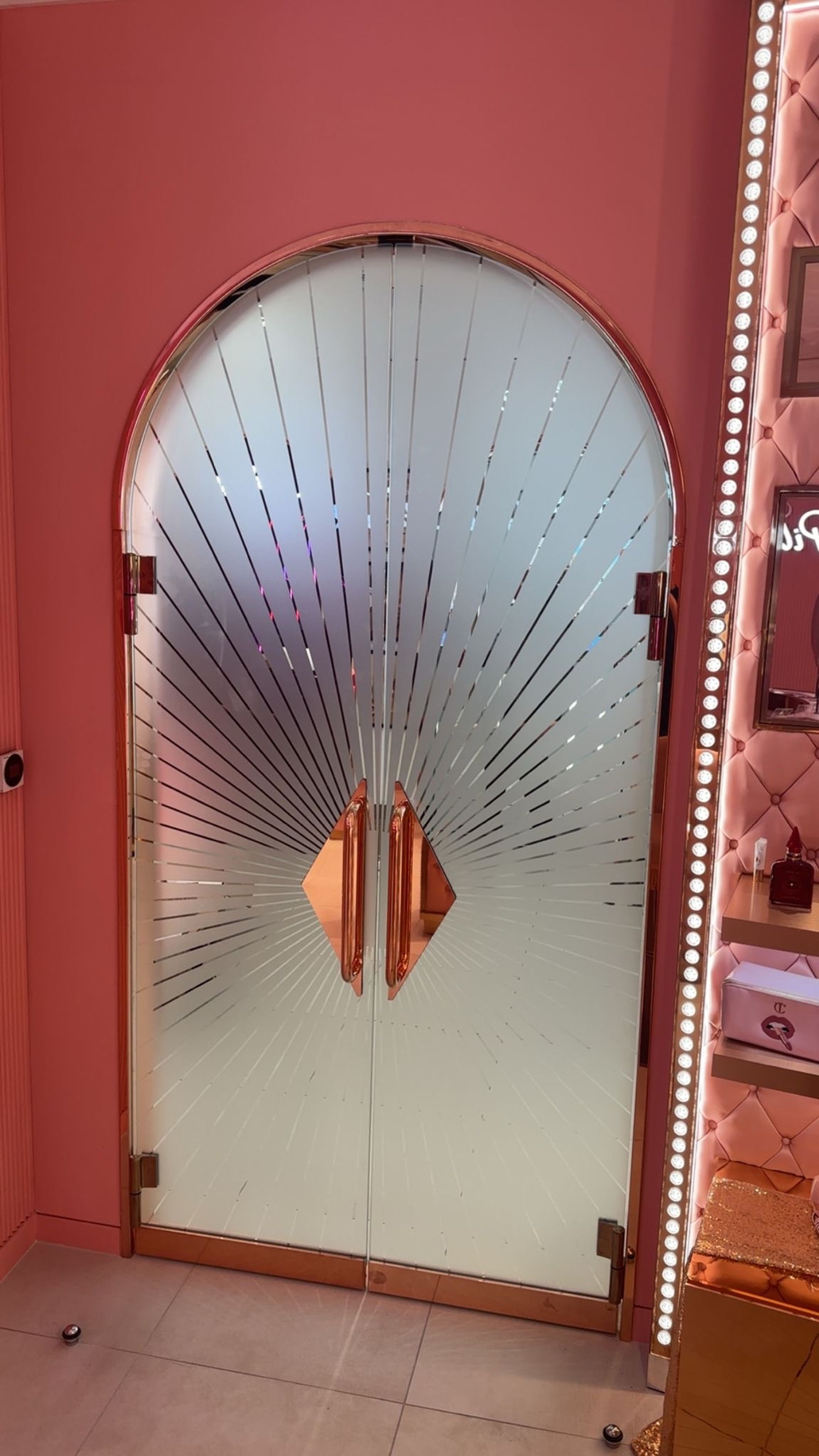 Arched patterned glass doors within the Charlotte Tilbury retail fit-out