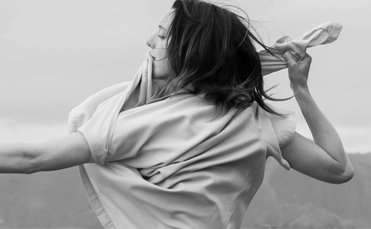 Black and white photo of Isabelle pulling her t-shirt across her face
