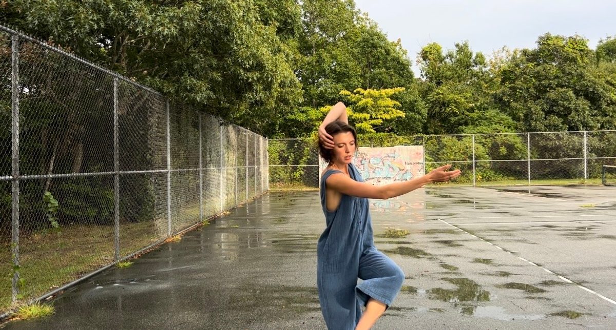 Isabelle dancing on a wet tennis court