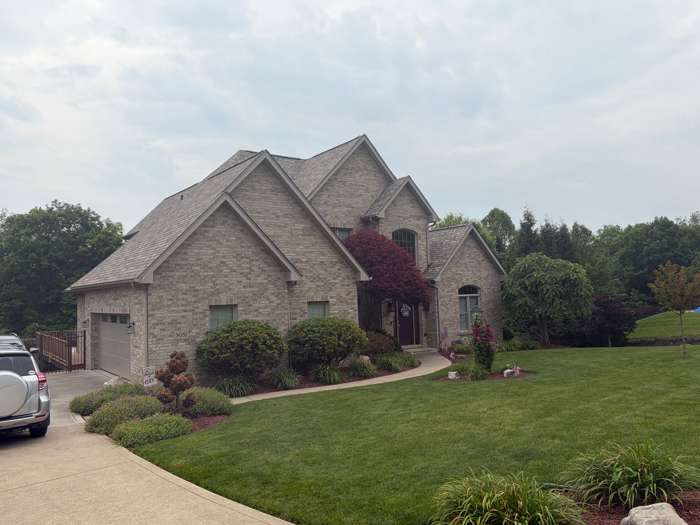 Completed roof replacement on a large brick home