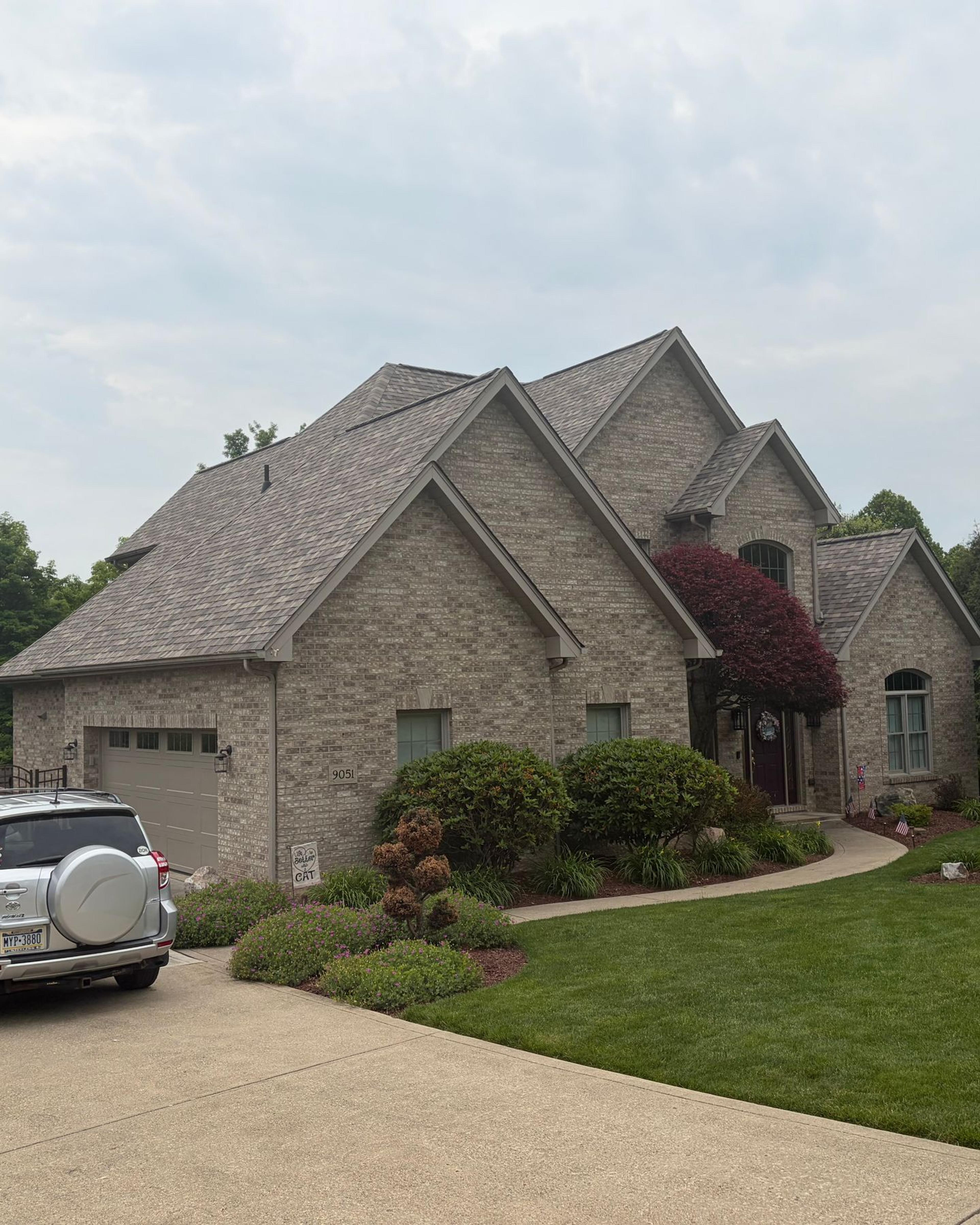 Brick home with finished roof, soffit and fascia