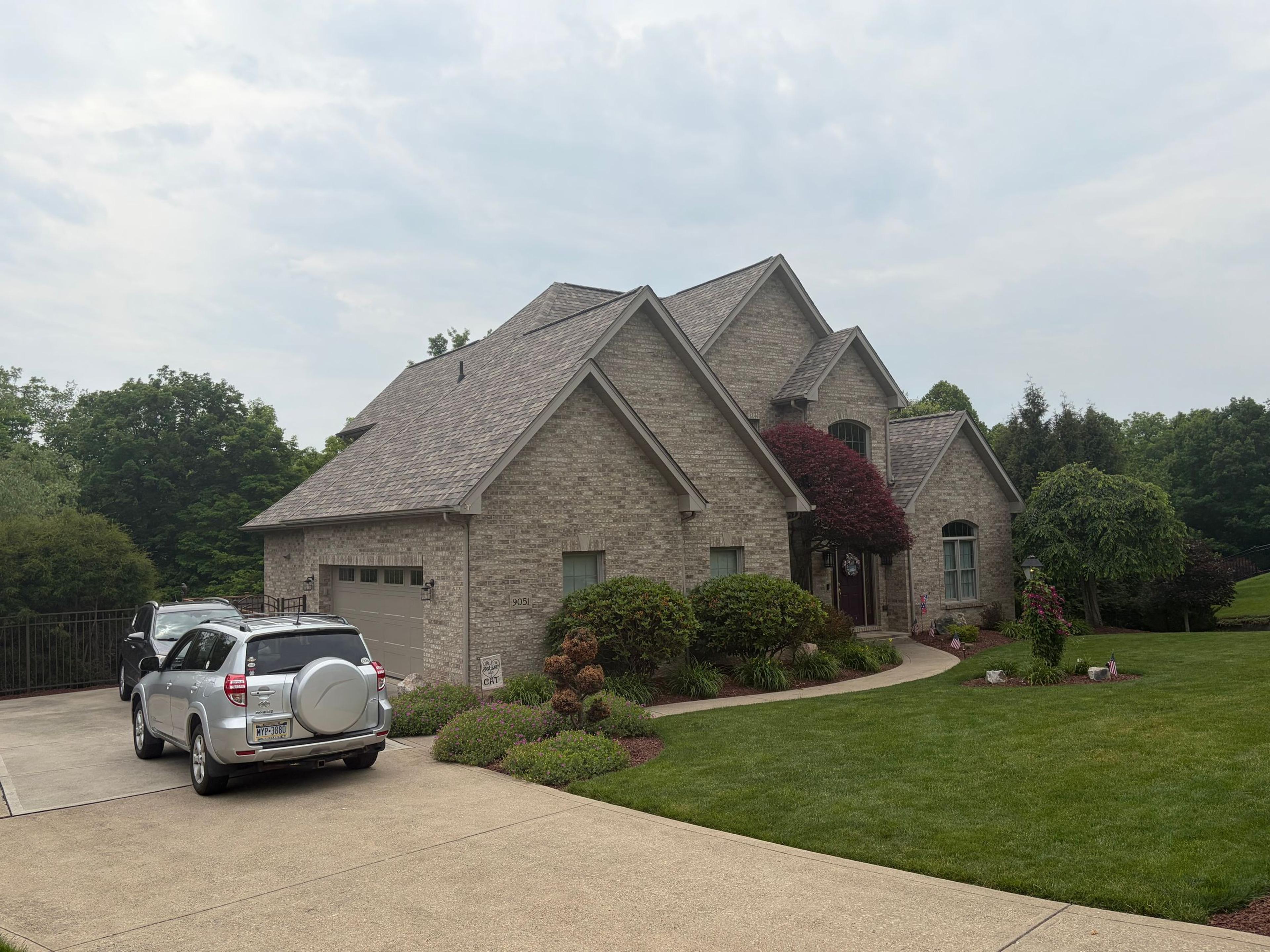 Brick home with finished roof, soffit and fascia