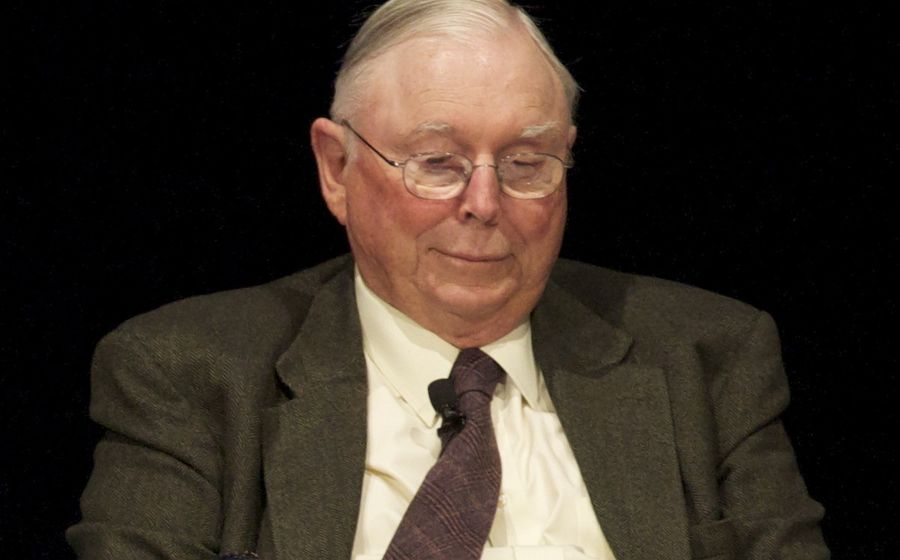 Picture of Charlie Munger reading with a plate of cookies
