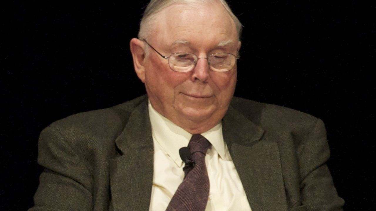 Picture of Charlie Munger reading with a plate of cookies
