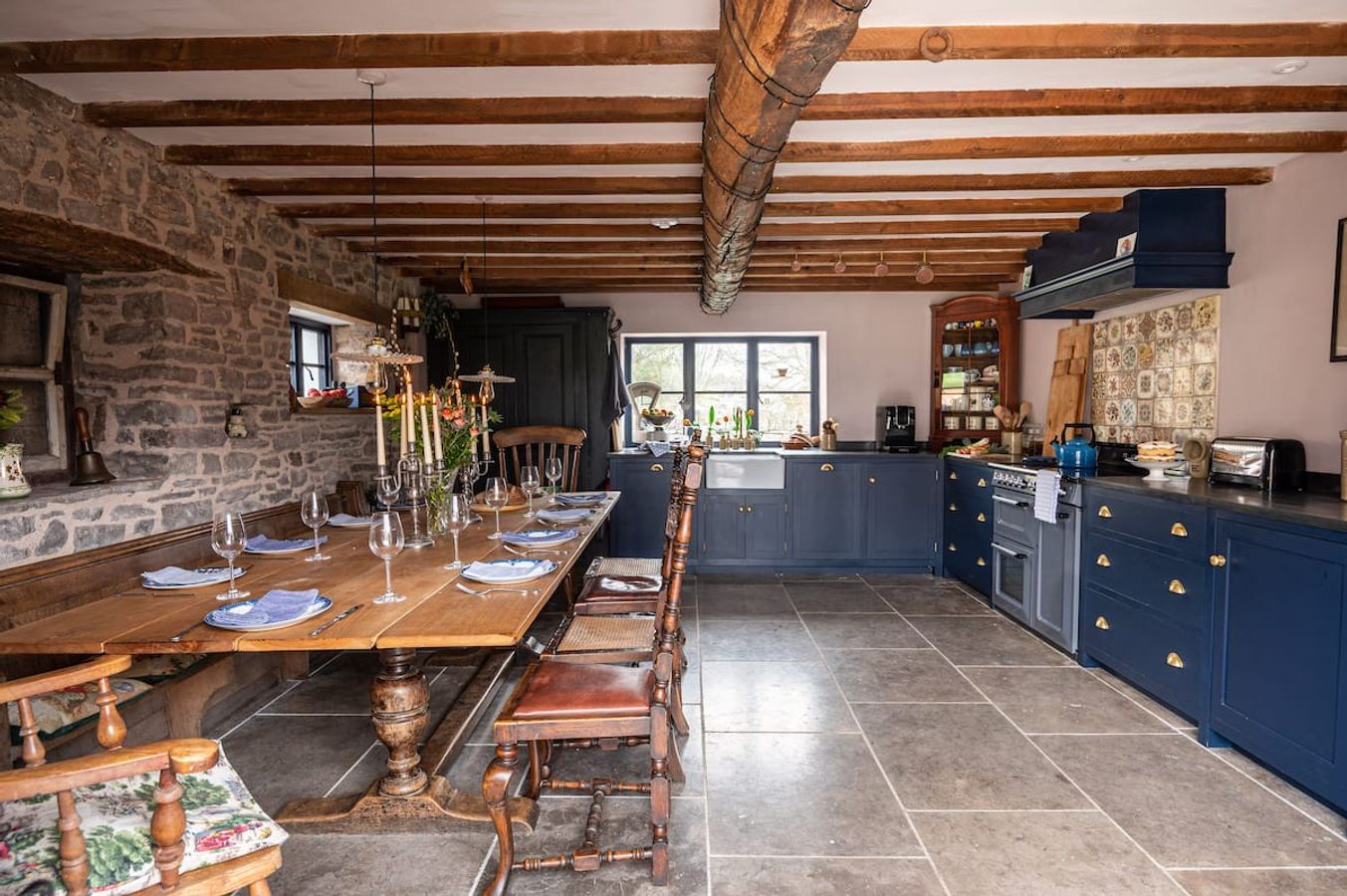 The long oak table, set for dinner