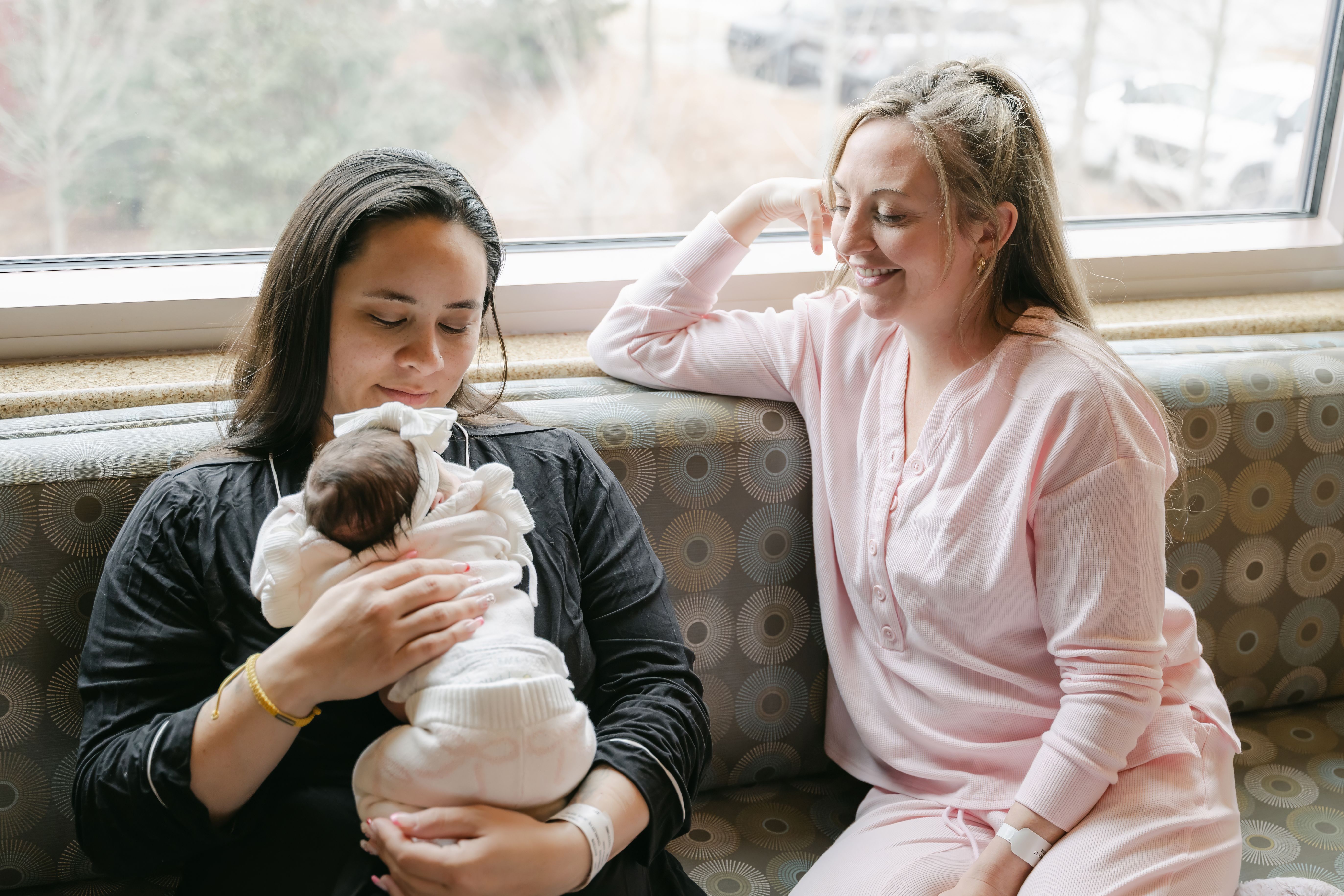 Two parents hold their newborn baby for the first time.
