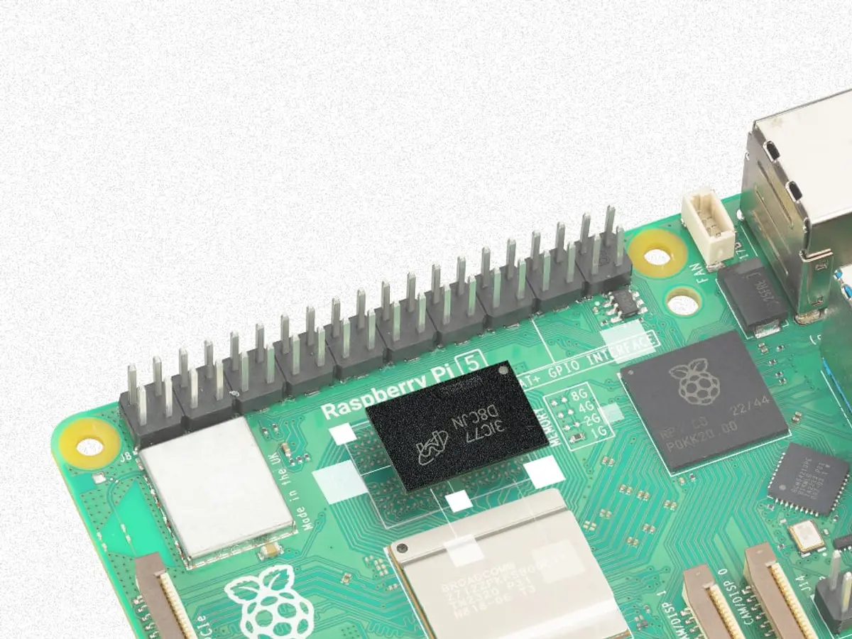 A Raspberry Pi 5 single-board computer photographed on a white background, with the Raspberry Pi 5 logo, GPIO header and memory options visible on the board.