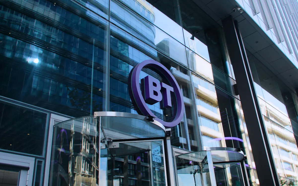 The BT logo sign above the glass entrance of a large office building