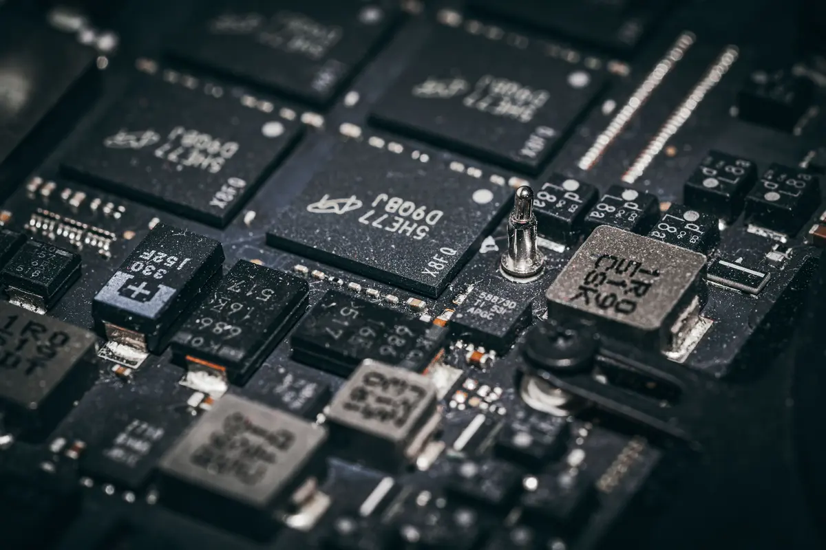 A close-up of microchips and components on a printed circuit board.