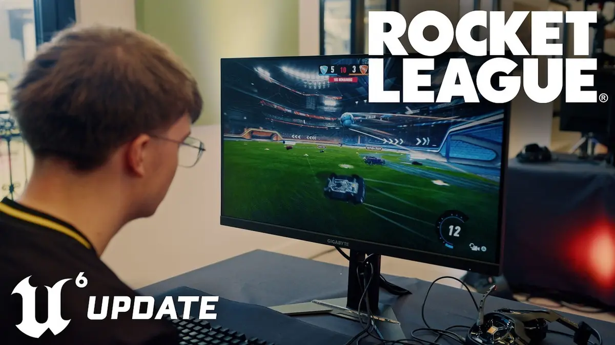 A Rocket League player in a headset sits at a desk watching a monitor showing a match in progress, with the Rocket League wordmark in the top corner and a blue Unreal Engine badge reading update in the opposite corner.