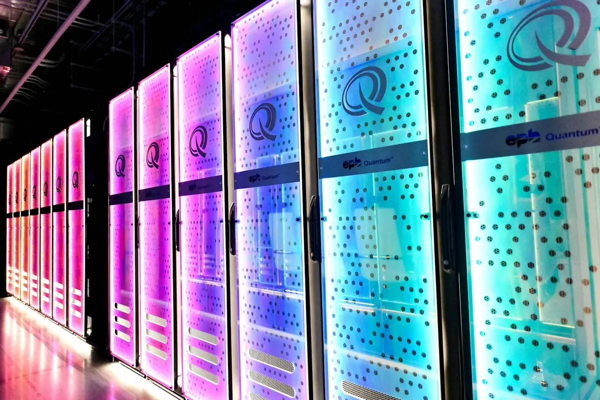 Rows of lit server racks in the EPB Quantum Center data hall, glowing pink and cyan in a darkened room