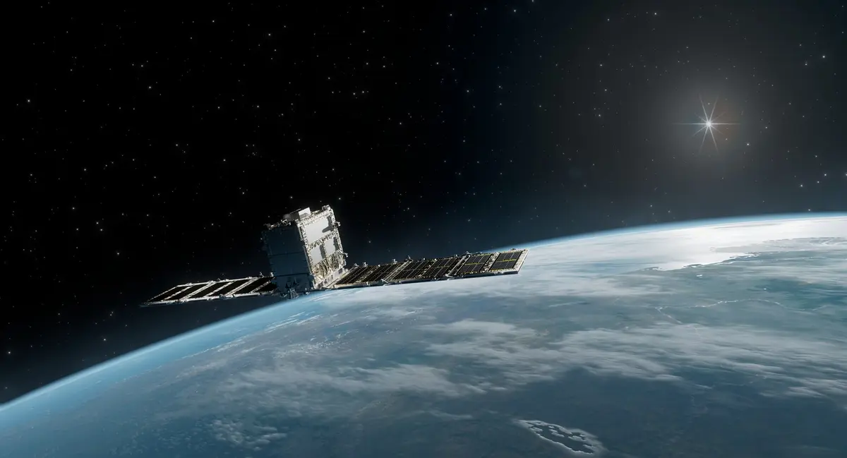 A Synspective StriX radar satellite in orbit above the curved limb of the Earth, its solar arrays deployed and a bright star burning behind it