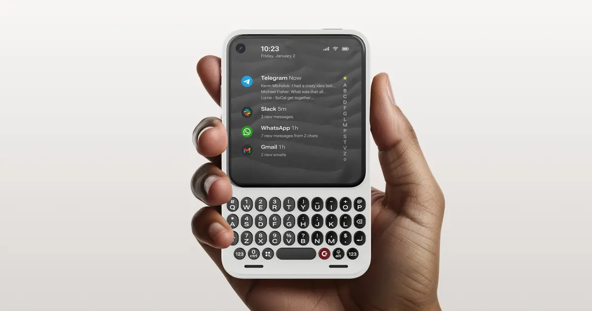 The Clicks Communicator, a smartphone with a physical QWERTY keyboard below its screen, held in one hand