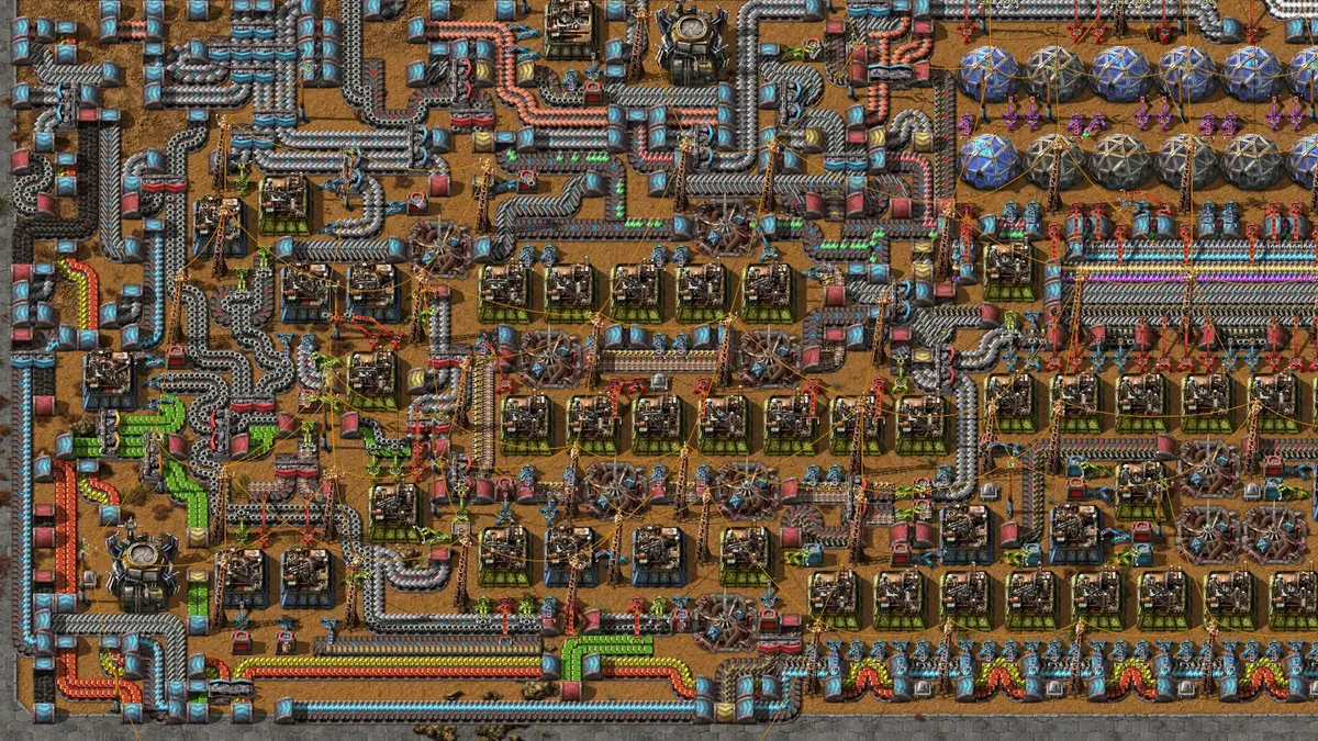 A densely packed Factorio factory seen from above, with belts of green circuits feeding rows of assembling machines