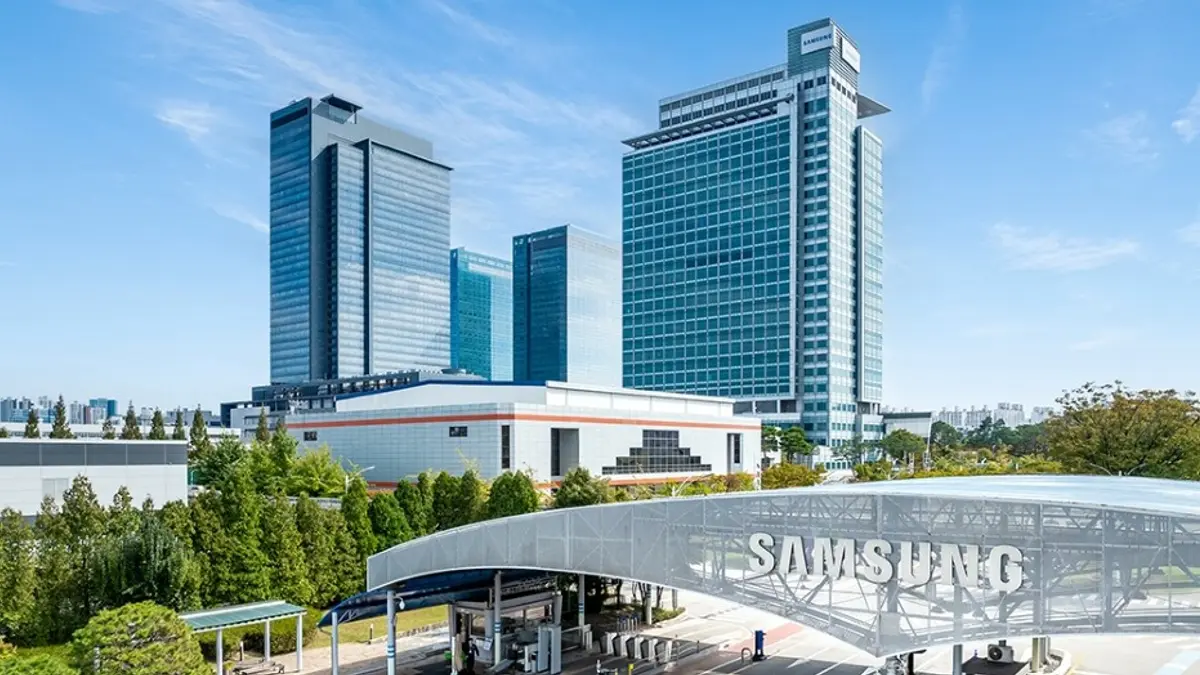 Samsung's corporate campus in Korea: glazed office towers and a low building seen above landscaped trees and an entrance canopy carrying the Samsung name.