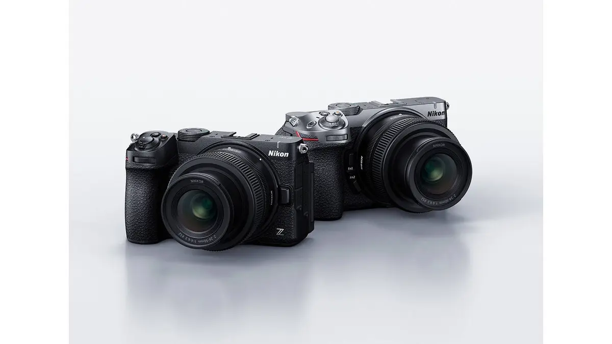 Two Nikon Z5IIC full-frame mirrorless camera bodies, one black and one silver, each fitted with a NIKKOR Z lens and posed side by side on a white background.