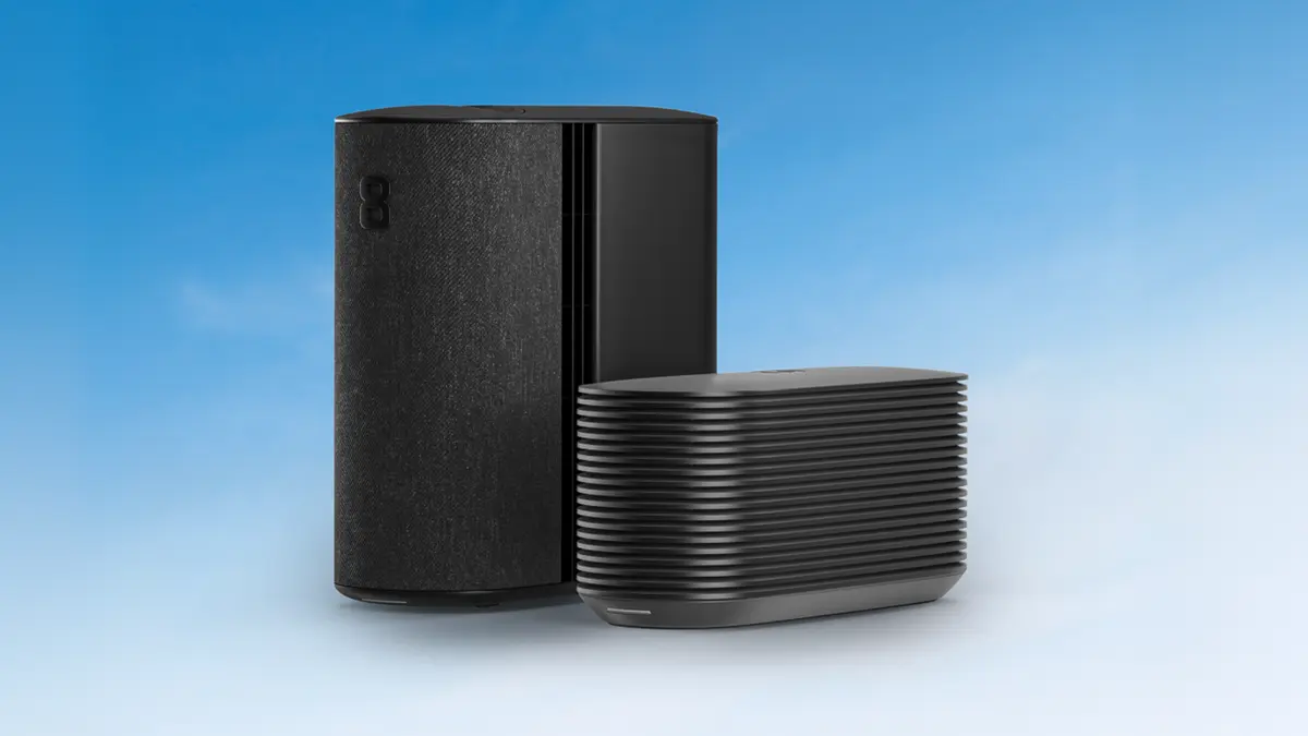 Eight Sleep's taller Pod 5 Hub with a fabric side panel standing beside the shorter, wider and horizontally ribbed Pod 6 Hub on a blue gradient background