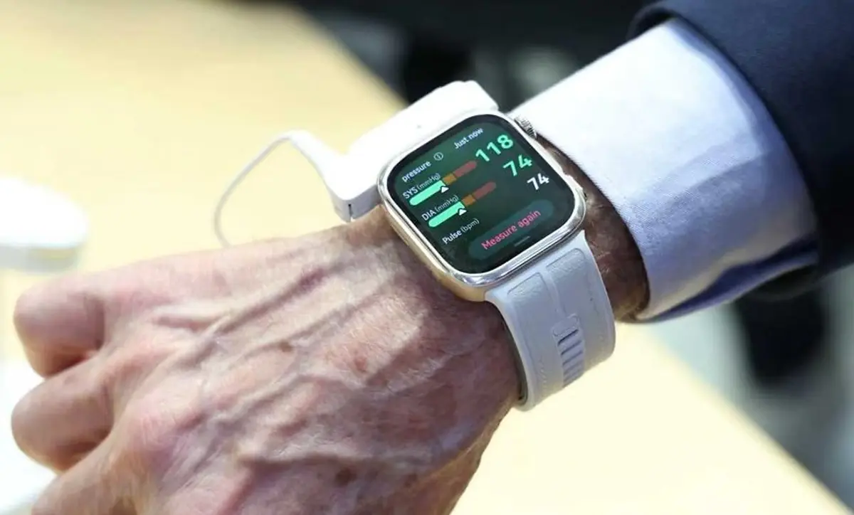 A HUAWEI WATCH blood-pressure reading displayed on a wearable device while worn on a user’s wrist.
