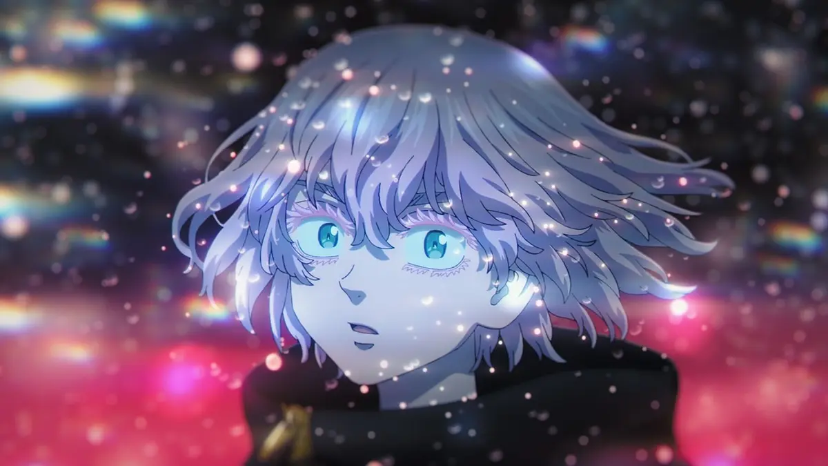 A close-up of Tokyo Revengers' Mikey, light-haired and blue-eyed, against a dark background scattered with pink and gold light