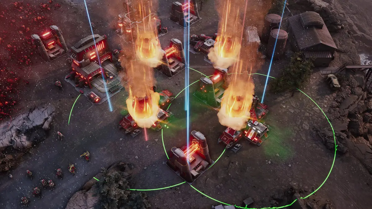 A Tempest Rising battle scene in which structures erupt into sheets of flame while red and blue energy beams cut across the battlefield, with infantry and tanks massed beneath them.