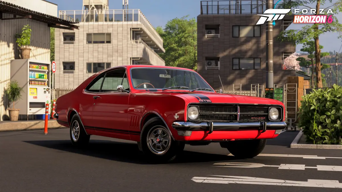 Forza Horizon 6 screenshot showing the 1968 Holden Monaro GTS 327, one of the update's new-to-Horizon cars, on a Japanese street beside a vending machine