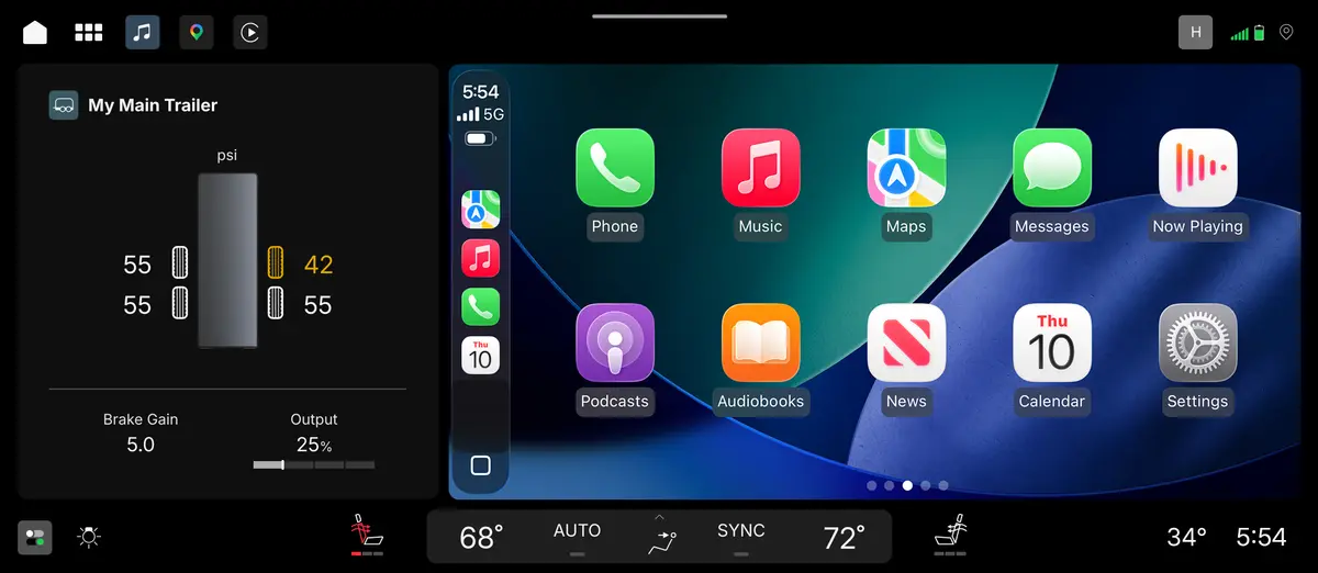 A truck infotainment home screen split between trailering pressure and brake-gain readings on the left and an Apple CarPlay app grid on the right