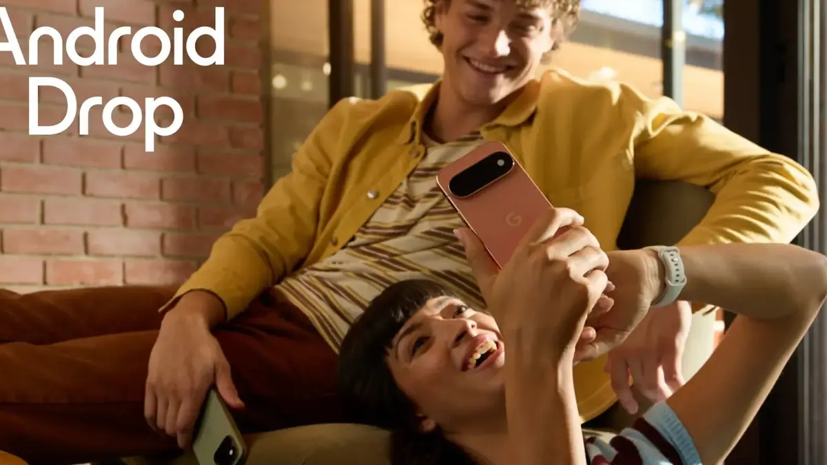 Google Android Drop campaign artwork: a woman lying back on a sofa holds up a rose-gold Pixel phone while a smiling man in a yellow jacket sits behind her, with the words Android Drop in white in the top left corner