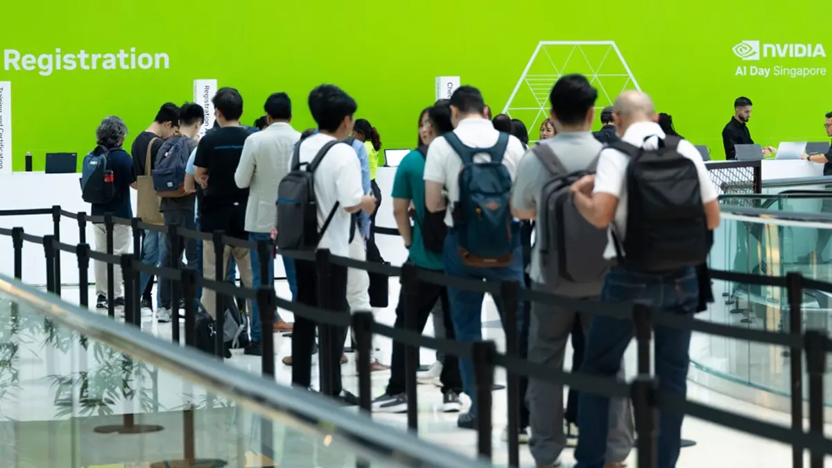 Attendees queueing at the AI Day Singapore registration desk beneath NVIDIA and AI Day Singapore signage on a green event wall