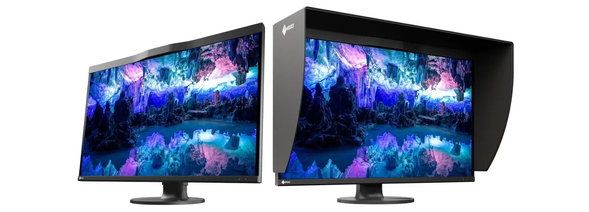 Two EIZO ColorEdge CG3200X professional monitors displaying a vivid cave scene, shown from the front with one fitted with a hood.