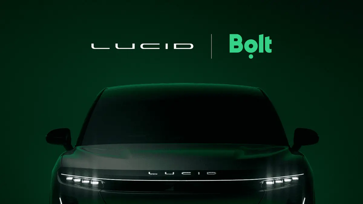 Official partnership artwork showing the Lucid and Bolt logos above the front of a dark Lucid car on a deep green background.