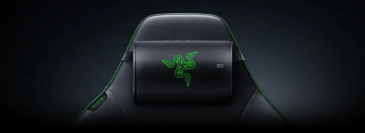 Official Razer image of a black high-back gaming chair headrest with green Razer branding and THX certification mark, showing the Clio X speaker cushion context.