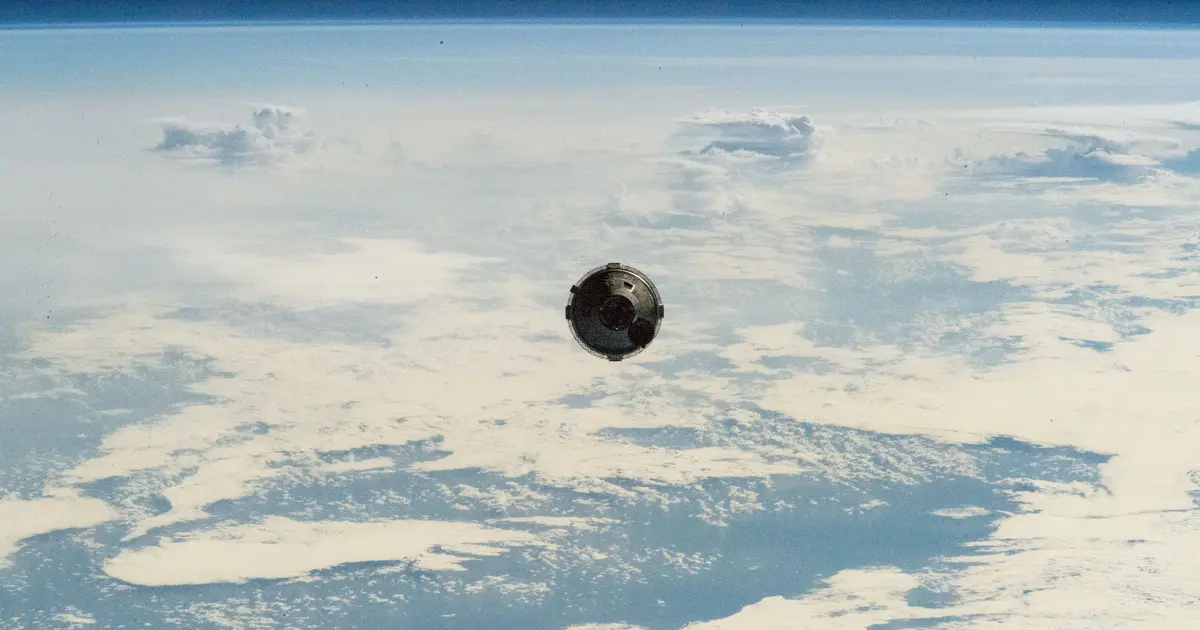 Boeing's Starliner spacecraft photographed from the International Space Station as it approaches, with cloud tops far below