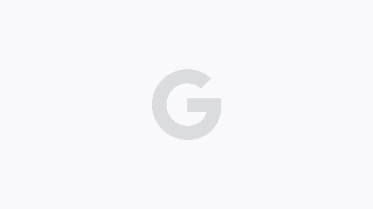 A pale grey Google G mark on a white background