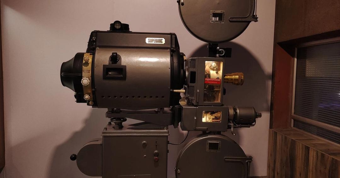 Imagen referencial: Un proyector de cine Superarc de estilo antiguo se exhibe en el interior, evocando la historia del cine.