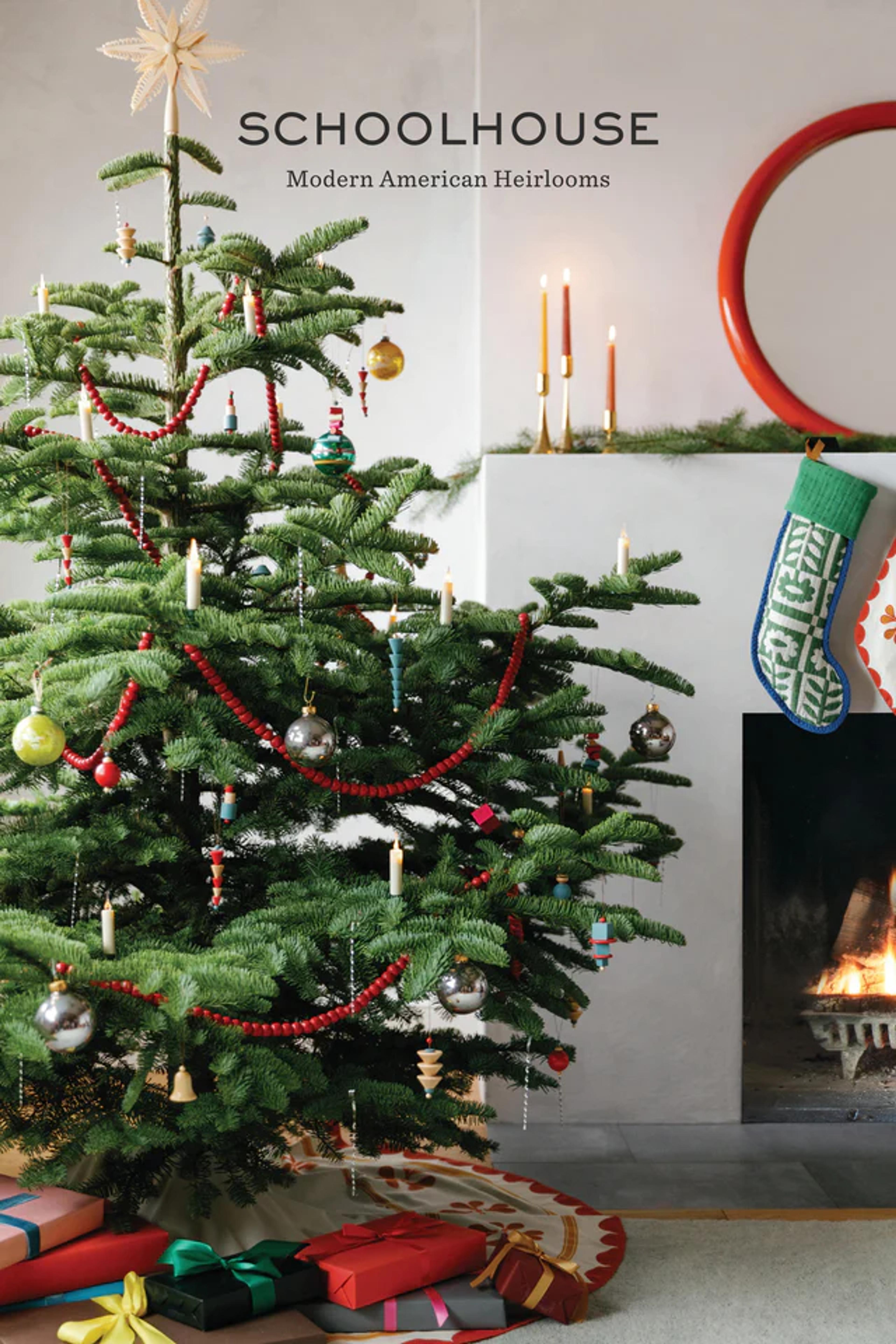 A Christmas tree with stockings over a fireplace