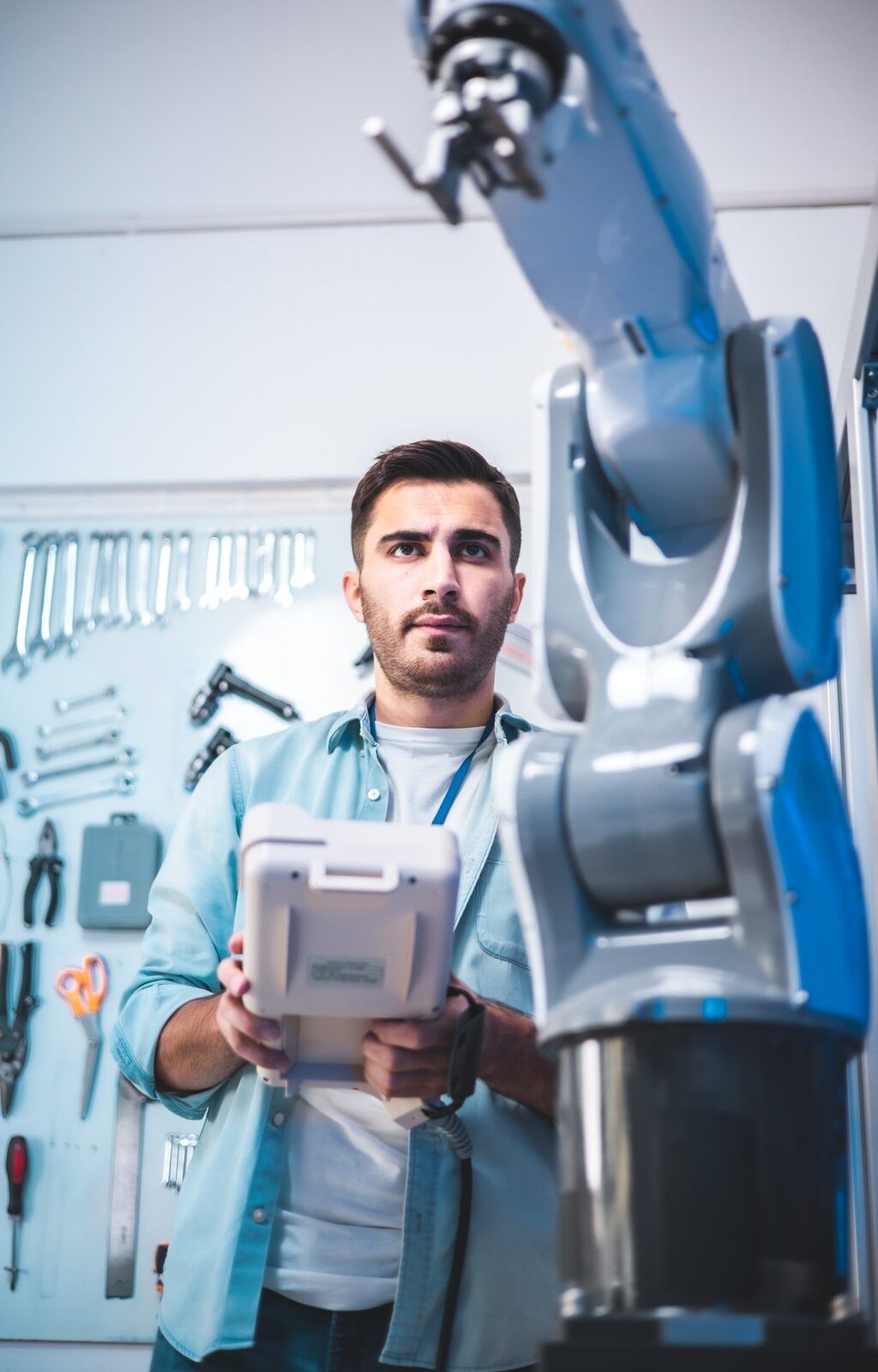 Man operating a robotic arm