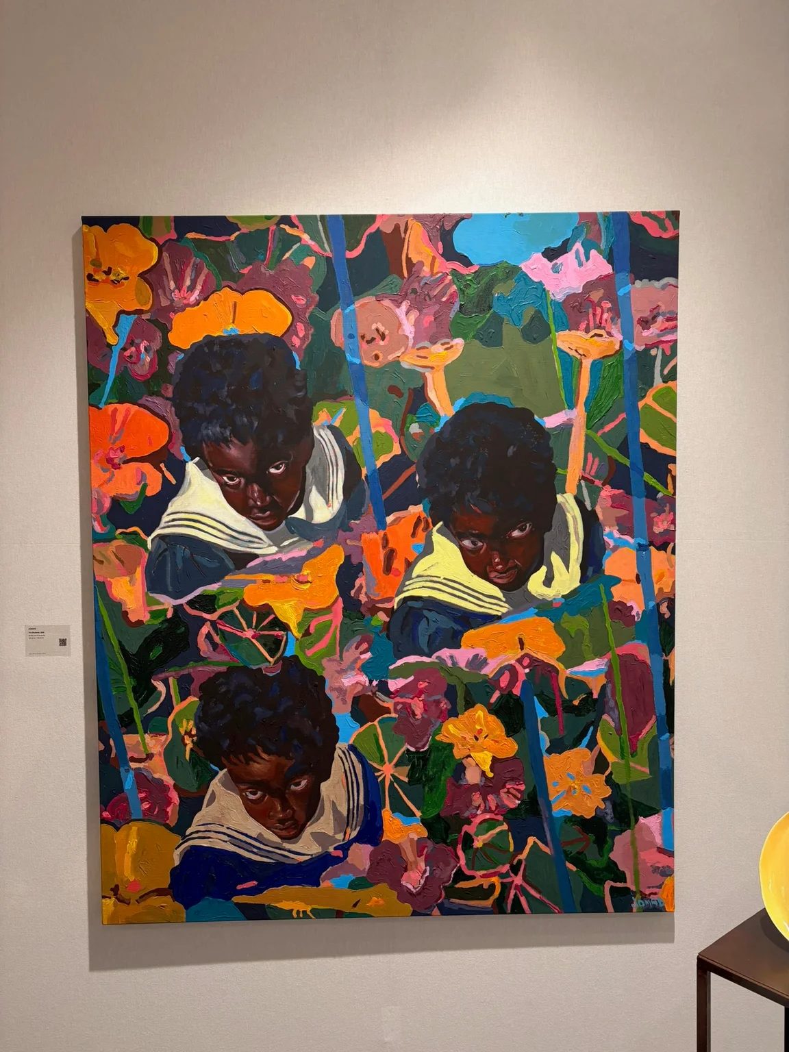A vibrant painting by Jomad with three repeated figures looking upwards through a field of brightly coloured flowers.