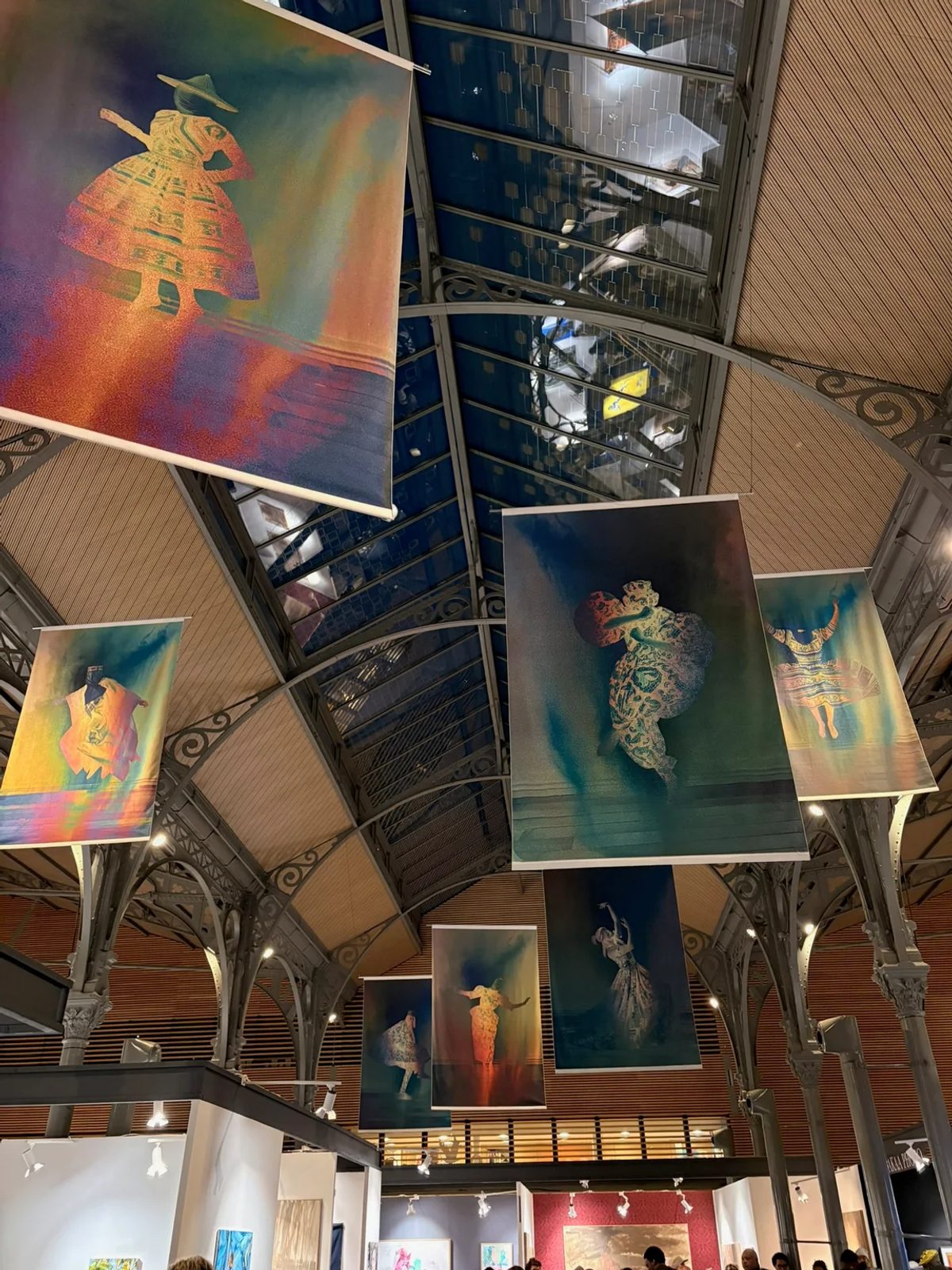 Gabriel Dia’s Mother’s Heritage: fabric photographs of dancing figures suspended beneath the Carreau du Temple roof at AKAA.