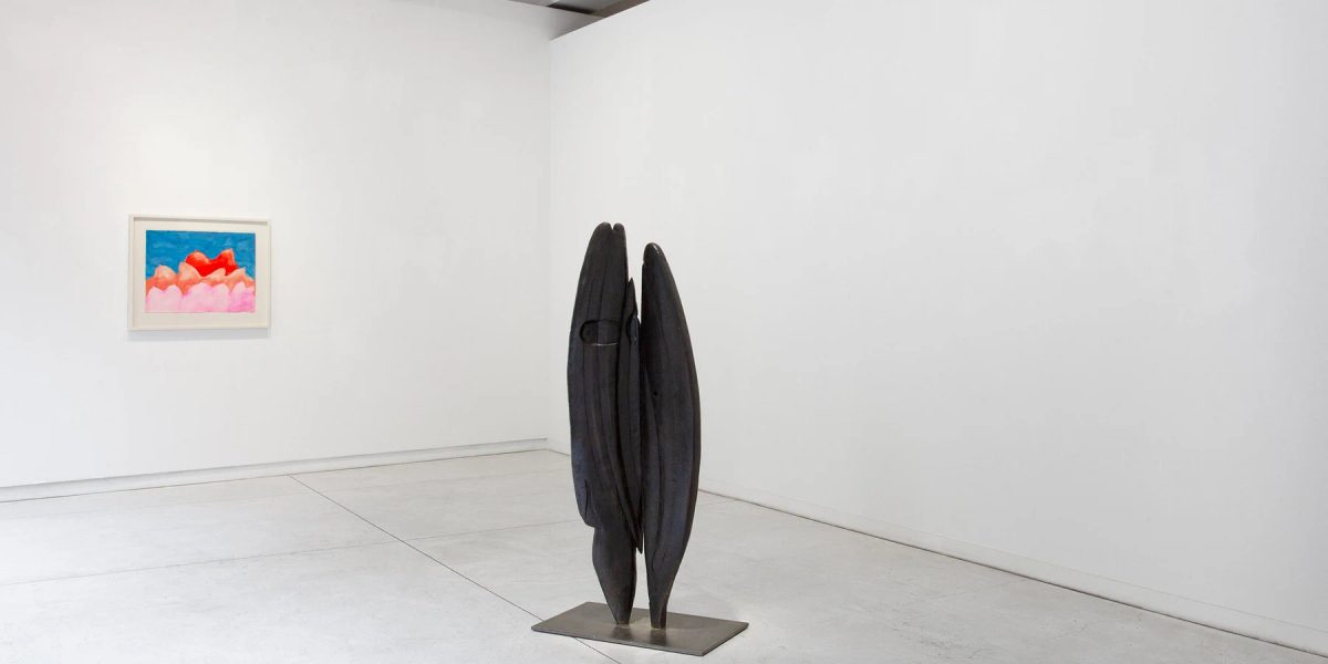 Louise Bourgeois exhibition at Galerie Karsten Greve, with a dark sculpture in the foreground and a colourful framed work on the wall.