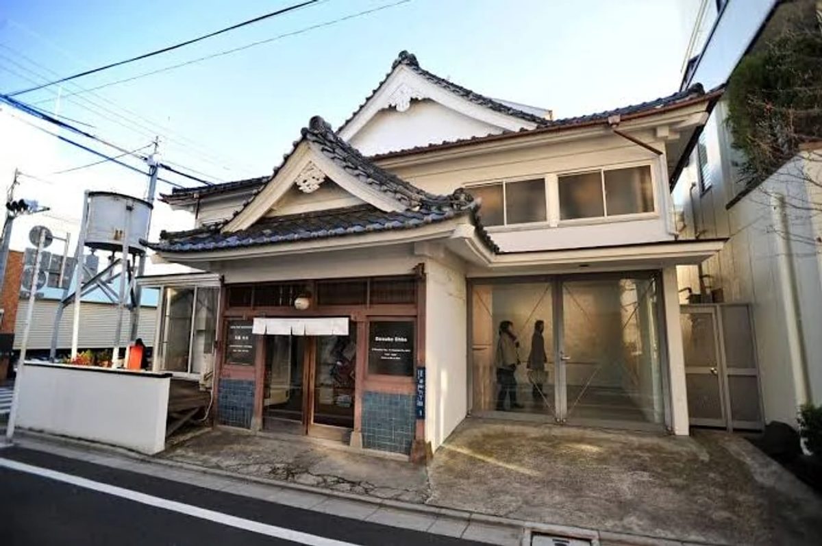 The entrance, tiled roof and water tower of SCAI The Bathhouse in Tokyo’s Yanaka neighbourhood.
