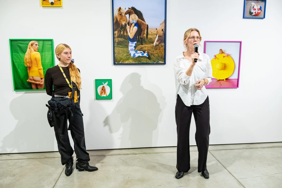 Emma Sarpaniemi on the left and Lilian Hiob-Küttis on the right, speaking beside Emma’s photographs at FOTO Tallinn.