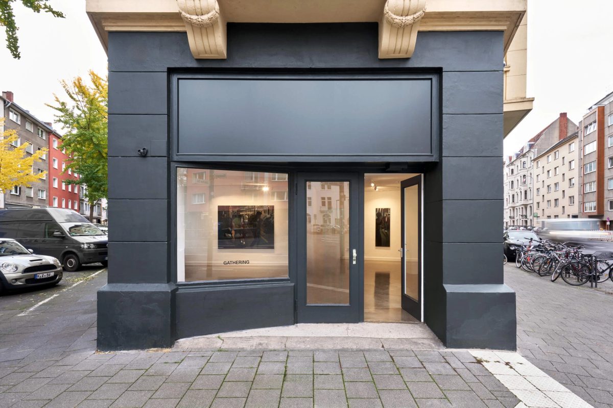 The corner gallery premises at Roonstraße 108, with Gathering signage and Laurie Smith paintings visible through the street-facing windows during its earlier use as Gathering Cologne.