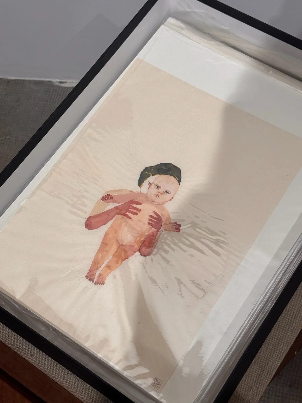 A work on paper by Maya Hewitt depicting a parent holding a baby, at Post-Fair Paris 2026.